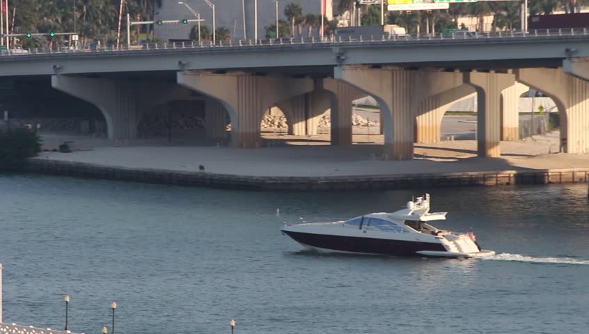 Traffic on the Venetian Causeway Bridge and boat in Biscayne Bay, Miami, Florida