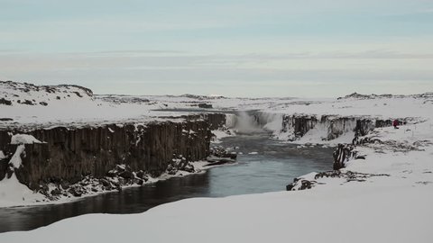 4K Time lapse of Sellfoss waterfall in Iceland in wintertime with a photographer making pictures
