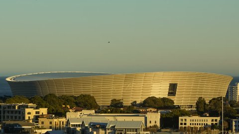 CAPE TOWN. SOUTH AFRICA - MARCH 18, 2011: Time lapse close up tilt shot during sunrise at Cape Town Greenpoint Stadium from elevated point of view.