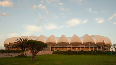 PORT ELIZABETH, SOUTH AFRICA - MAR 21, 2010: 4K Timelapse sunrise of the Nelson Mandela Bay Stadium. It was built to resemble the national flower of South Africa, a giant protea.