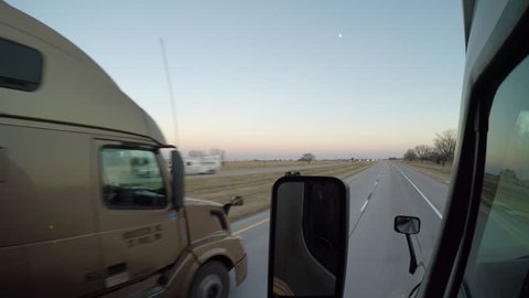 External POV shot of a Semi-Truck being overtaken by another Semi-Truck on Interstate 80 near Lexington, Nebraska, USA on 12/09/16.
