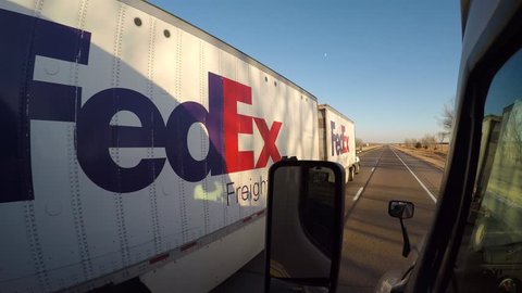 External POV shot of a Semi-Truck being overtaken by a FEDEX Semi-Truck on Interstate 80 near Lexington, Nebraska, USA on 12/09/16.