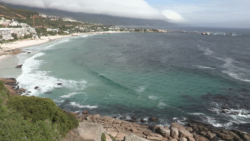 Wide of Clifton Beach, Cape Town with seagulls flying in the foreground 
