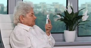 Old Woman Talking with Nephews on Cell Phone Video Call Conversation Mobile Home. Ultra High Definition, UltraHD, Ultra HD, UHD, 4K, 2160P, 4096x2160