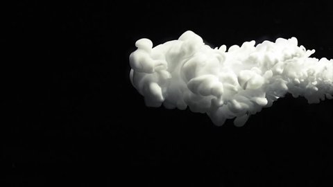 White paint cloud spraying on a black background.