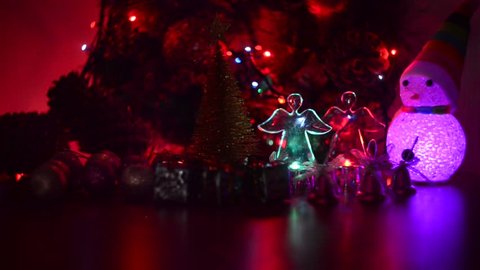 Glowing snowman, angels and garlands. Christmas arrangement.