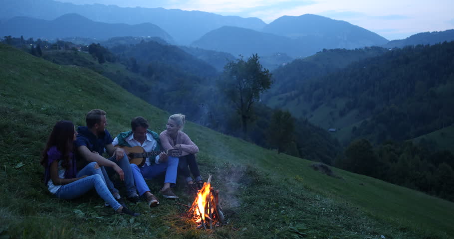 Young Group Of Friends Enjoying Together Playing Guitar Singing Bonfire Mountain. Ultra High Definition, UltraHD, Ultra HD, UHD, 4K, 2160P, 4096x2160