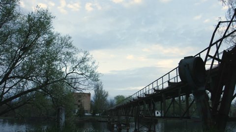 Nature and Towns That Were Damaged. Boats Near the Bridge, Calm, Quiet Riverbed. Ancient Buildings and Abandoned Cities in the Exclusion Zone. Rusty Bridge. Stairs Leading to the Bridge. Trees