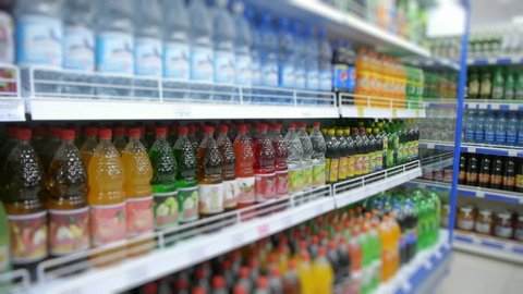 fizzy drinks on the supermarket shelf, blurry