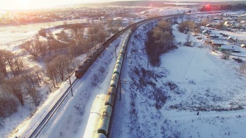 Top view of two freight trains with carriages on railways at winter