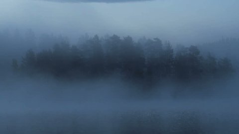 moving of fog on the lake during sunrise in early morning in finland