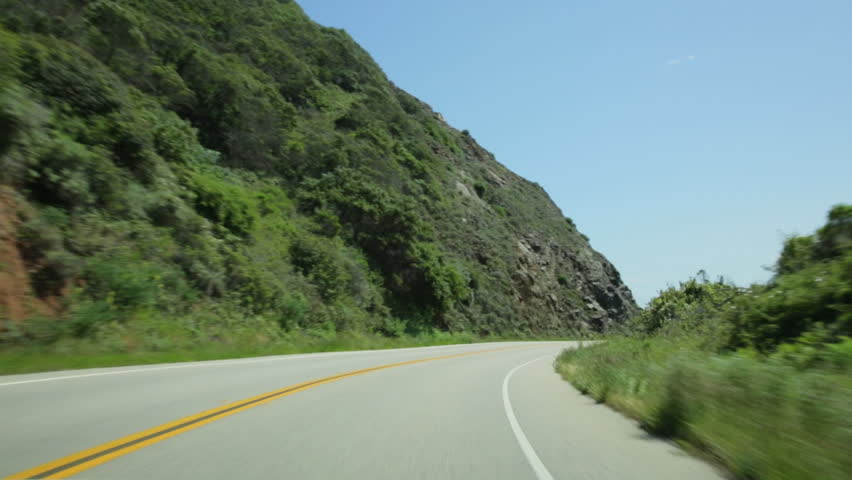 Vehicle point-of-view driving on California Highway 1 (aka Cabrillo Highway or Pacific Coast Highway) in the Big Sur area of Central California.