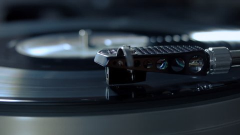 Turntable stylus going down. record playing on a vinyl record player. close-up