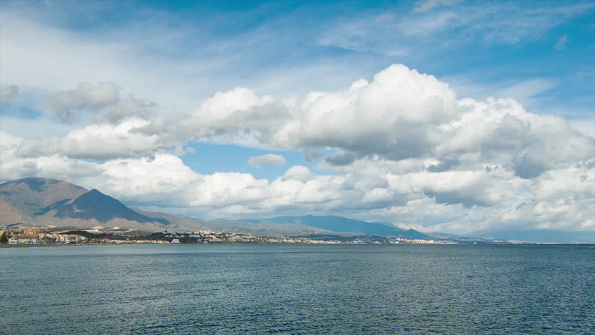 Southern Spain Mediterranean Coastline at Estepona with Dramatic Clouds Over Mountains Bordering the Ocean
