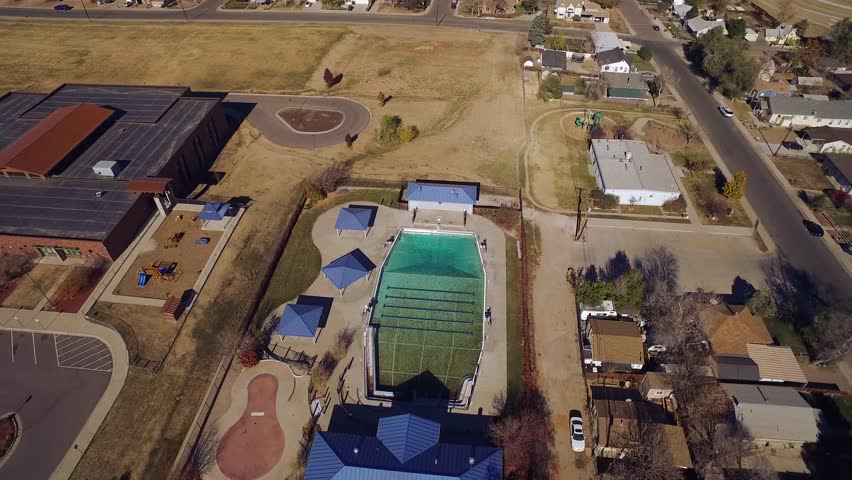 aerial view of a town, including a large swimming pool