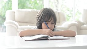 Happy kid writing at home