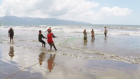 MAROANTSETRA, MADAGASCAR OCTOBER 19.2016 Native fishermen fishing on sea, using traditional technique pulling net. Life of indigenous peoples in countryside. 