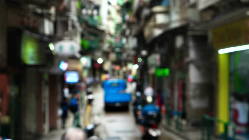 Macao - Defocused people walking in small street. 4K resolution. October 2016