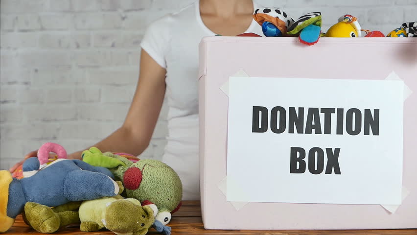 Woman prepare to donate toys in charity shop. Slow motion | Shutterstock HD Video #22367656