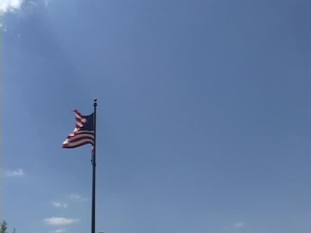 US flag with plane flying by