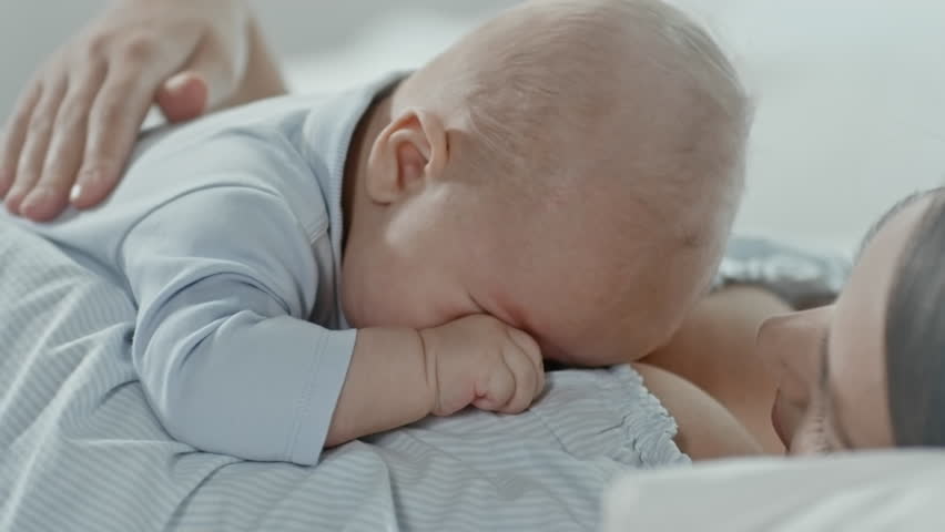 baby sleeping on chest of mother