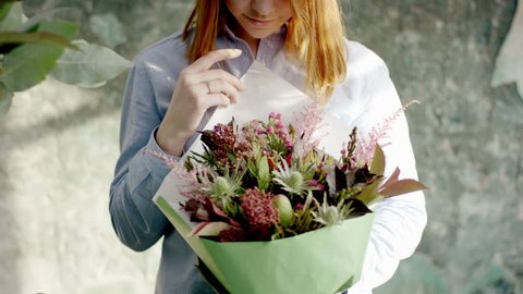 Beautiful florist presenting bouqet