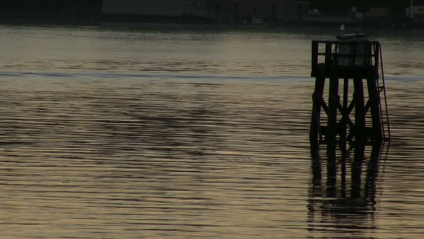 Zoom out from Buoy to Newport Bay in Oregon at sunset