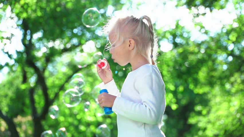Little Girl Blowing Soap Bubbles Stock Footage Photo