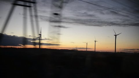 Wind power plants in sunlight. The view from the train window. 