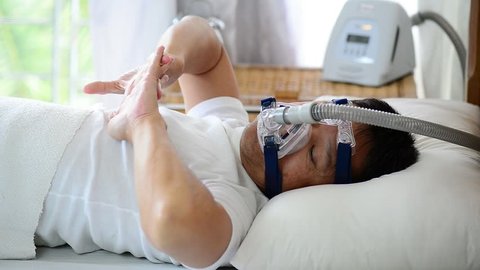 Healthy senior man wearing cpap mask waking up freshly with  smiling face from smooth sleeping all night long,healthcare concept.Obstructive sleep apnea therapy.