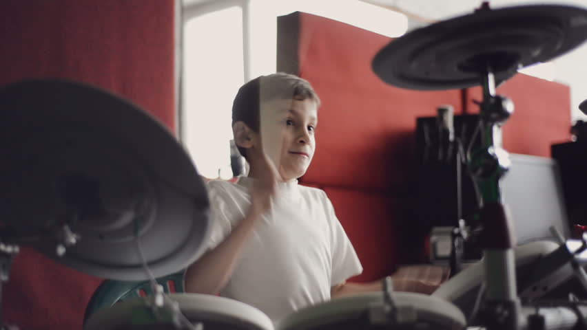 little boy playing electronic drums