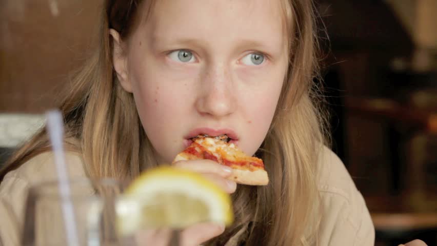 Young Girl Eating A Pizza Stock Footage Video 100 Royaltyfree