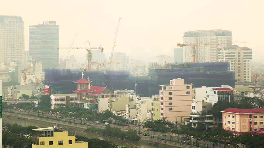 Multiple construction cranes working in a residential area of Ho Chi Minh City. Vietnam. Timelapse.