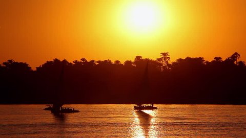 Feluccas & Tourist Boats At Sunset; River Nile Luxor Egypt