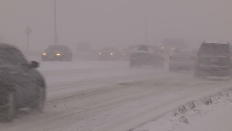 Massive blizzard with zero visibility for drivers on highway in snow
