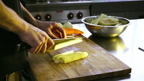 sliced eggplants on a wooden Board. Prepare the eggplant before frying in the pan. Vegetarian cooking and nutrition