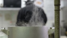 Steaming pot of food in a professional kitchen - Powered by Shutterstock - Get 15% off with code: PIKWIZARD15