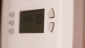 Digital thermostat used for heating and cooling - Energy expense and finance concept