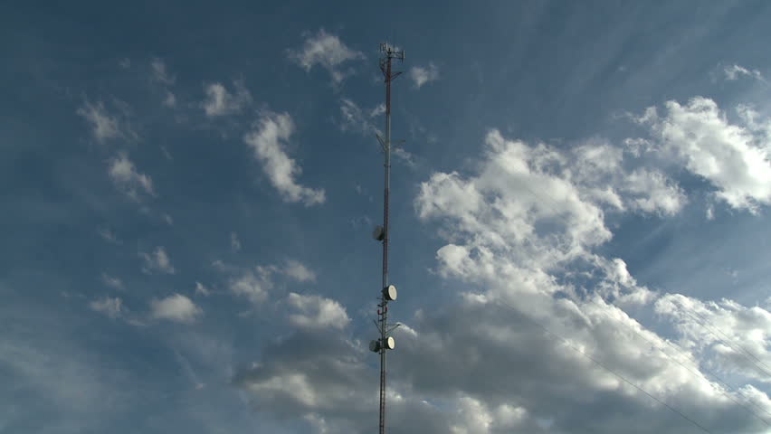 Time Lapse of clouds moving past a communications tower