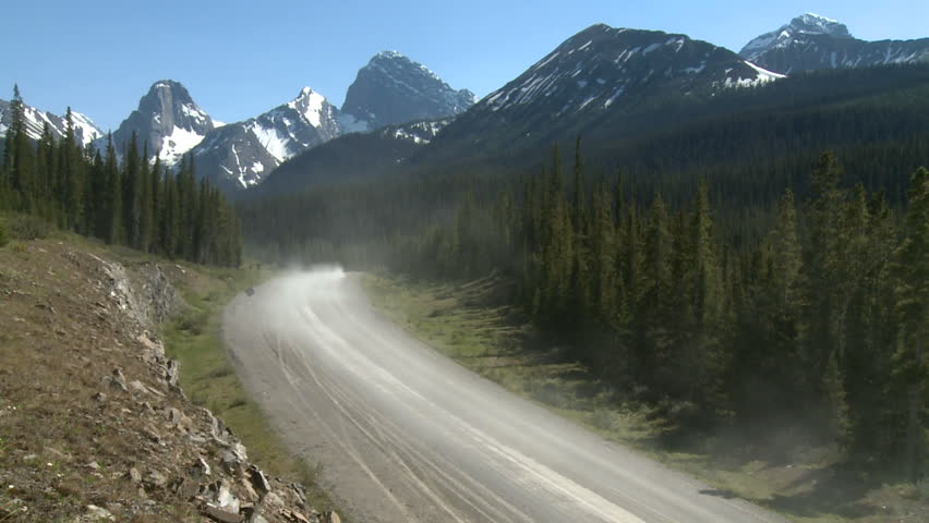 Car on back country gravel road in the Rocky Mountains