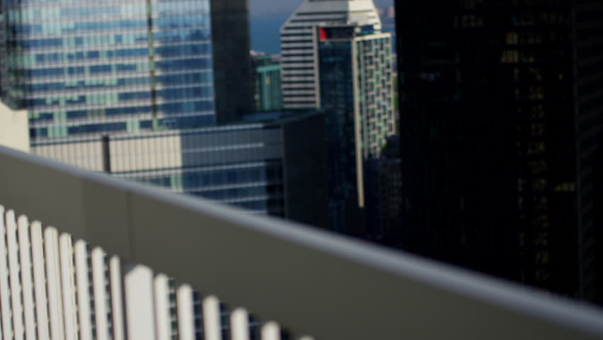 Ambitious Asian American male business consultant using touchscreen technology on city rooftop skyscraper Chicago RED DRAGON