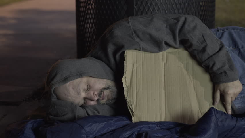Person gives money to homeless man laying on sidewalk 4k | Shutterstock HD Video #22442536