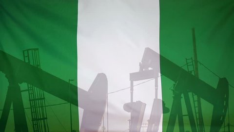 Concept oil production in Nigeria oil pumps and nigerian flag in slow motion movement