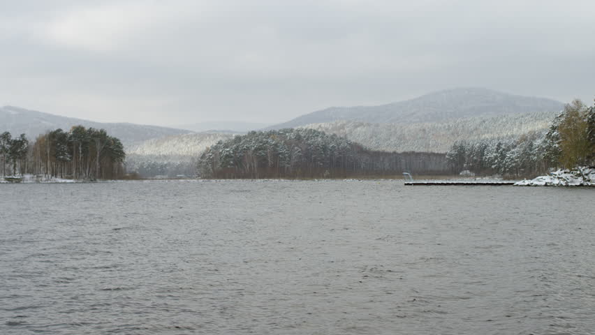 view of a man looking at winter lake