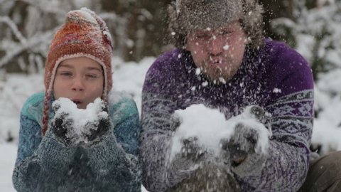 Portrait of a father and sons playing snowballs. Man and child in the park in winter. Family play snowballs in the winter in nature. 