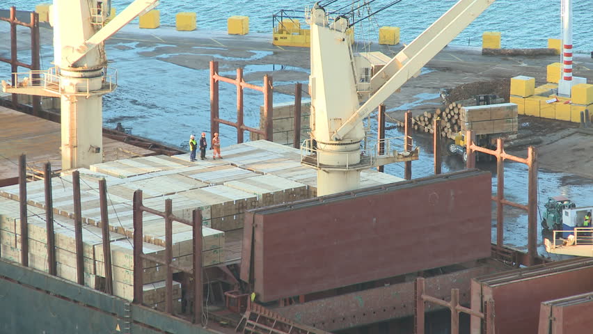 Timber being loaded on a ship for export. Timelapse