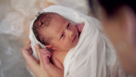 newborn baby relaxing in bathtube