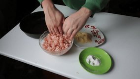 Preparing mince for meatballs. Male bachelor ineptly forming patties and puts the pan. Video shot on the Canon 70D
