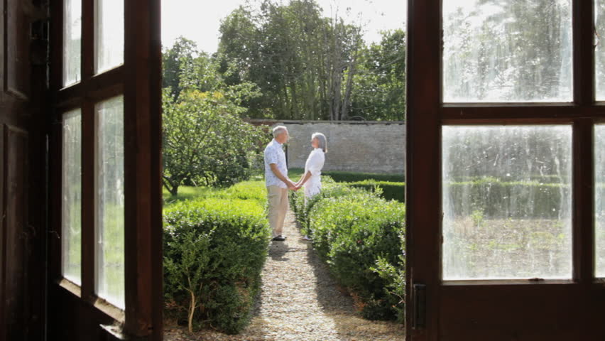 Mature couple walking in the garden