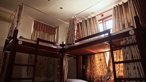 Hotel room with empty bunk beds in a small room of the Asian hostel in Vietnam.